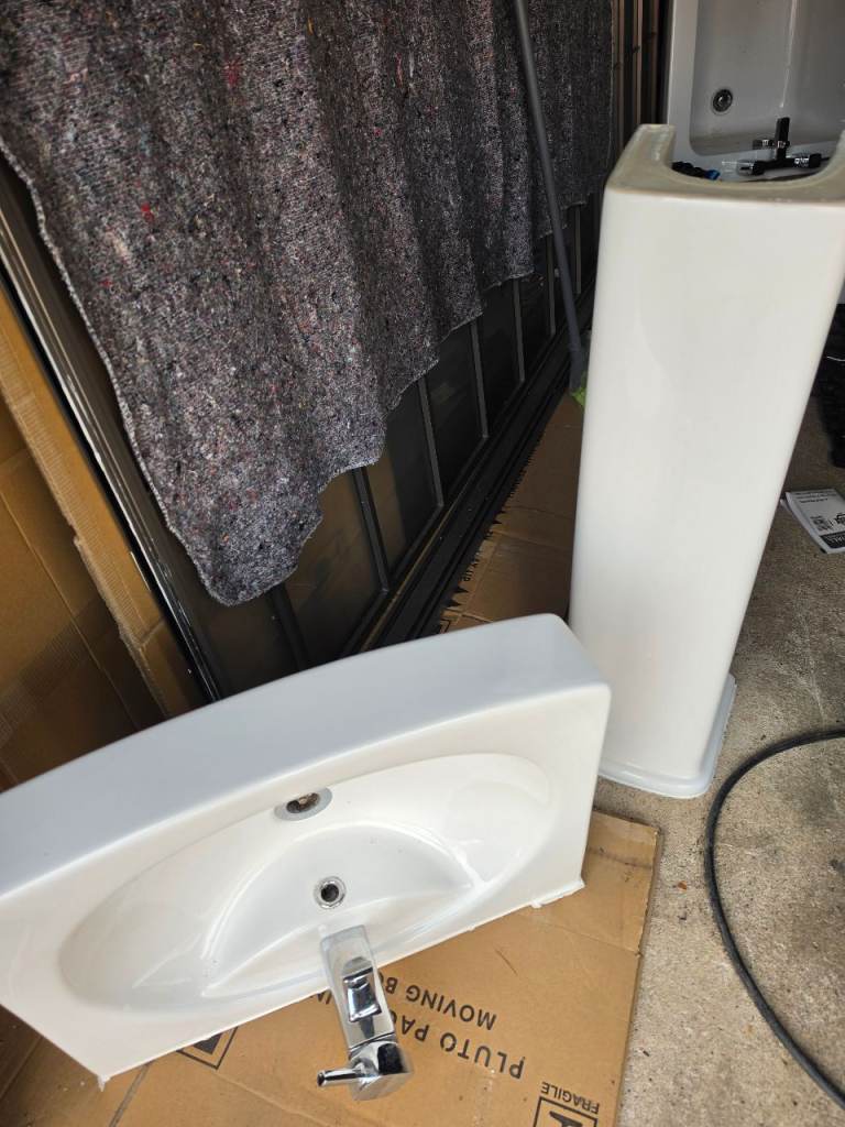 Bathroom bath tub, sink, toilet and shower unit.