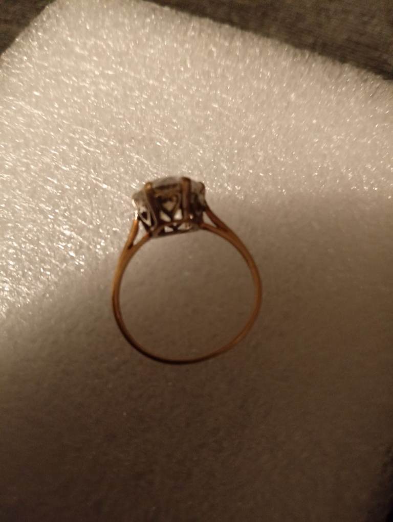 A lab made diamond white gold with hearts around the top and a 14 caret yella gold