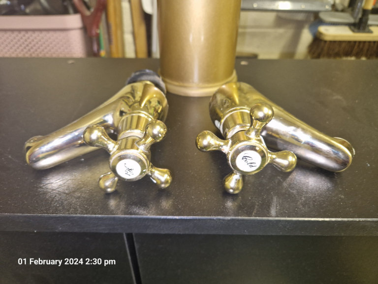  Bathroom mirror, roll holder & bath taps.