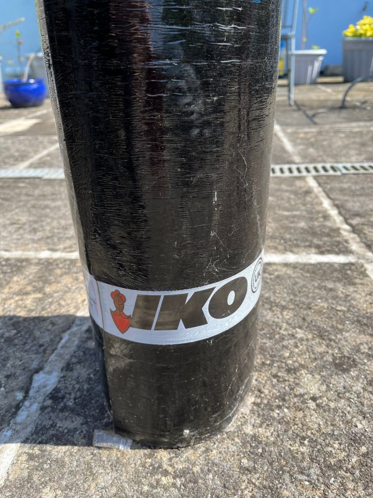 IKO TGX torch on roofing cap felt.