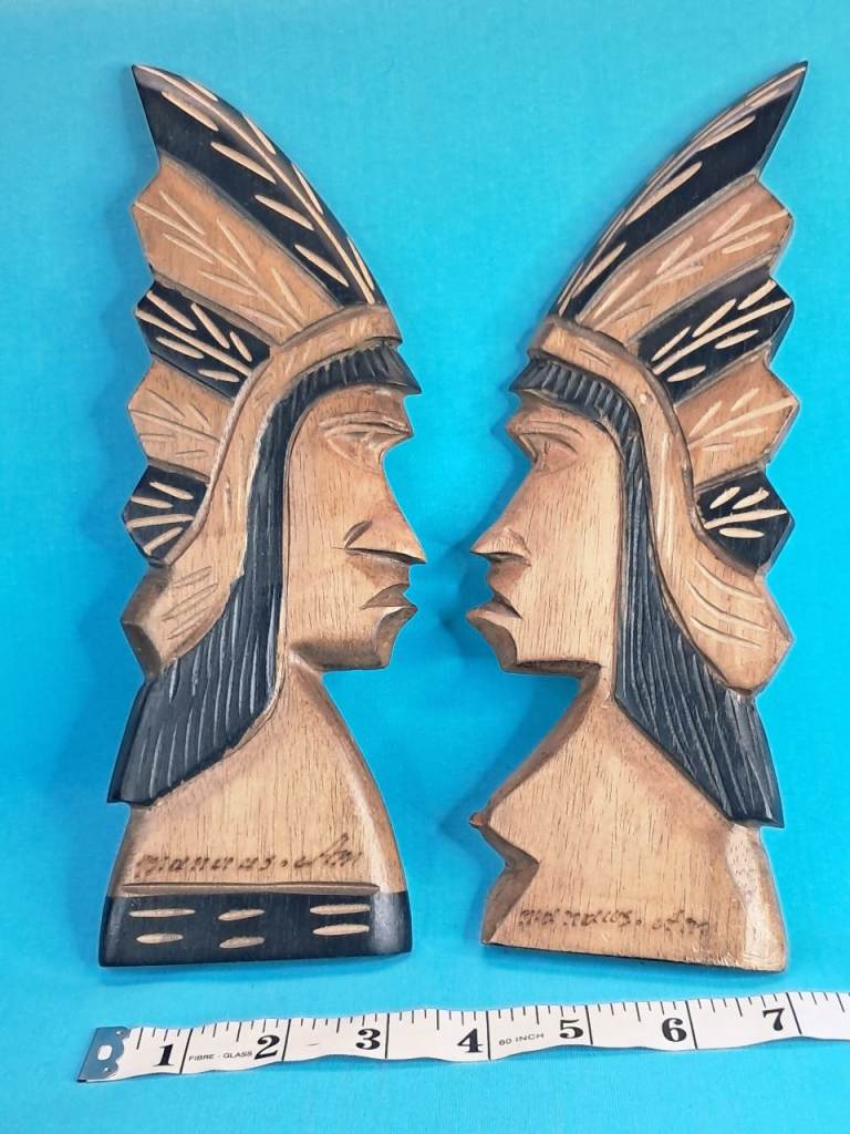 vintage hand-carved wood sculptures depicting Native American chief profiles. 