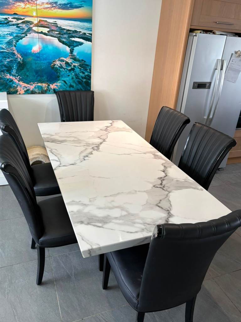 Marble composite table and black leather chairs
