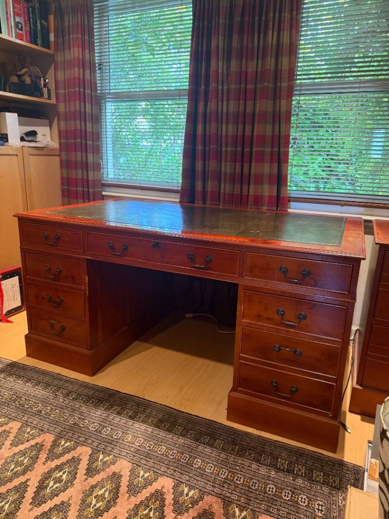 Large reproduction desk with matching filing cabinet and leather swivel desk chair.