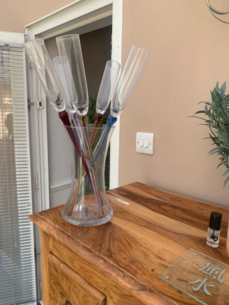 Long stemmed champagne glasses in vase