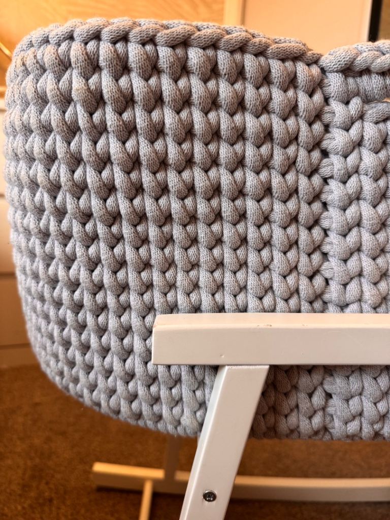 Light grey crochet crib with white wooden stand 
