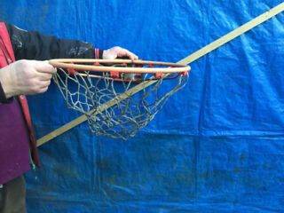 Basketball catch frame and net for mounting on wall