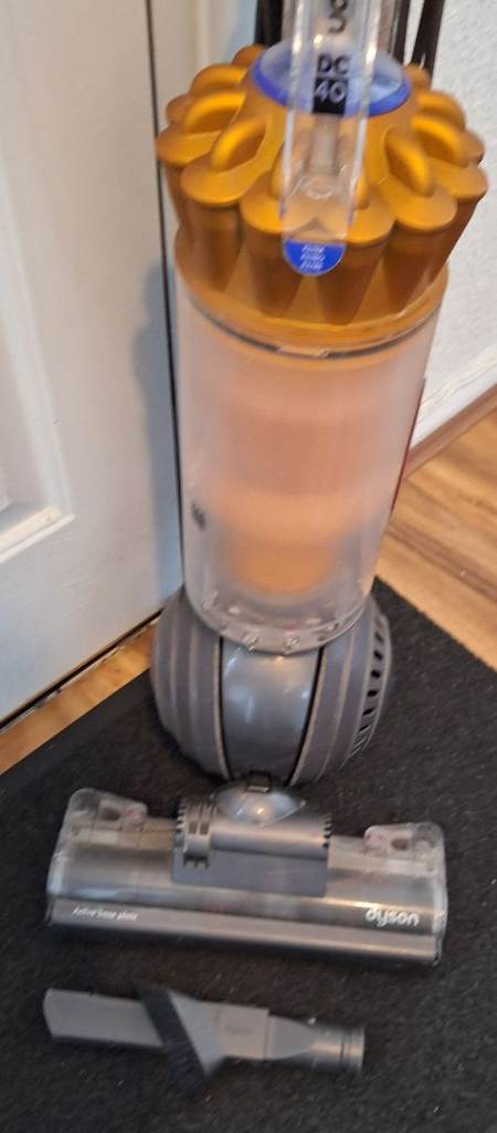 Dyson,DC40 vacuum cleaner working, with attachment. 