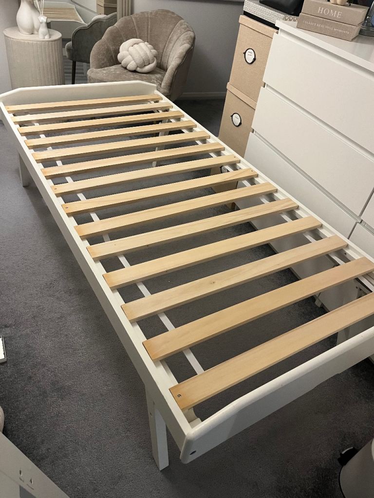 Single white wooden bed and quest bed 