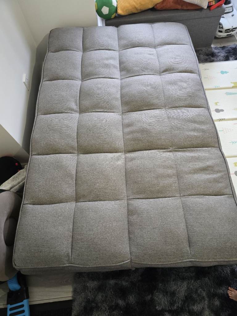 Grey sofa with bed