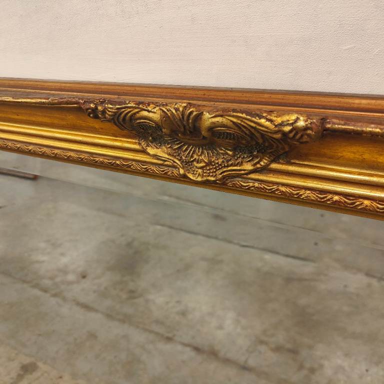 A large Victorian style gilt mirror.