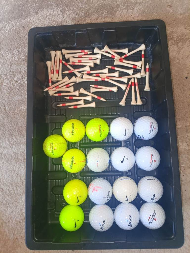 Selection of golf balls and tees.