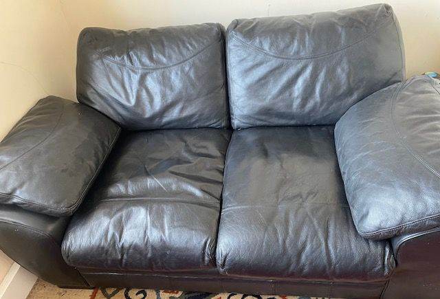 Black faux leather sofa £65 ono