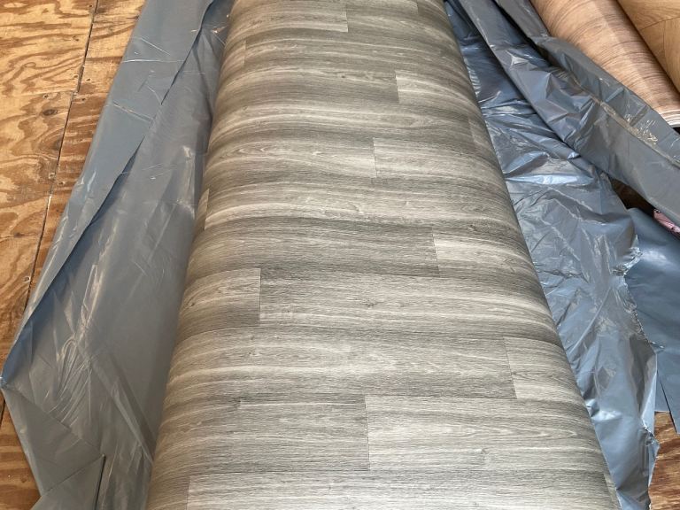 A new 2.49 x 2m grey wood vinyl.