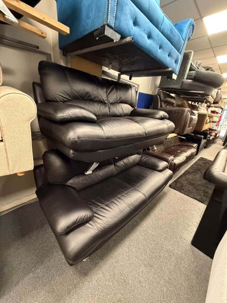 3 and 2 seater sofa in a black leather hyde throughout on chrome feet £350