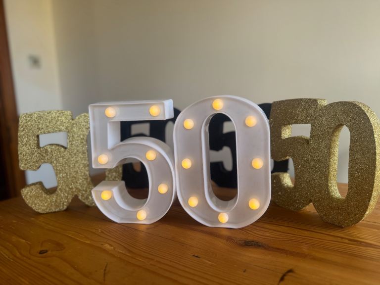 50 signs for birthday or anniversary. Includes light up numbers. 