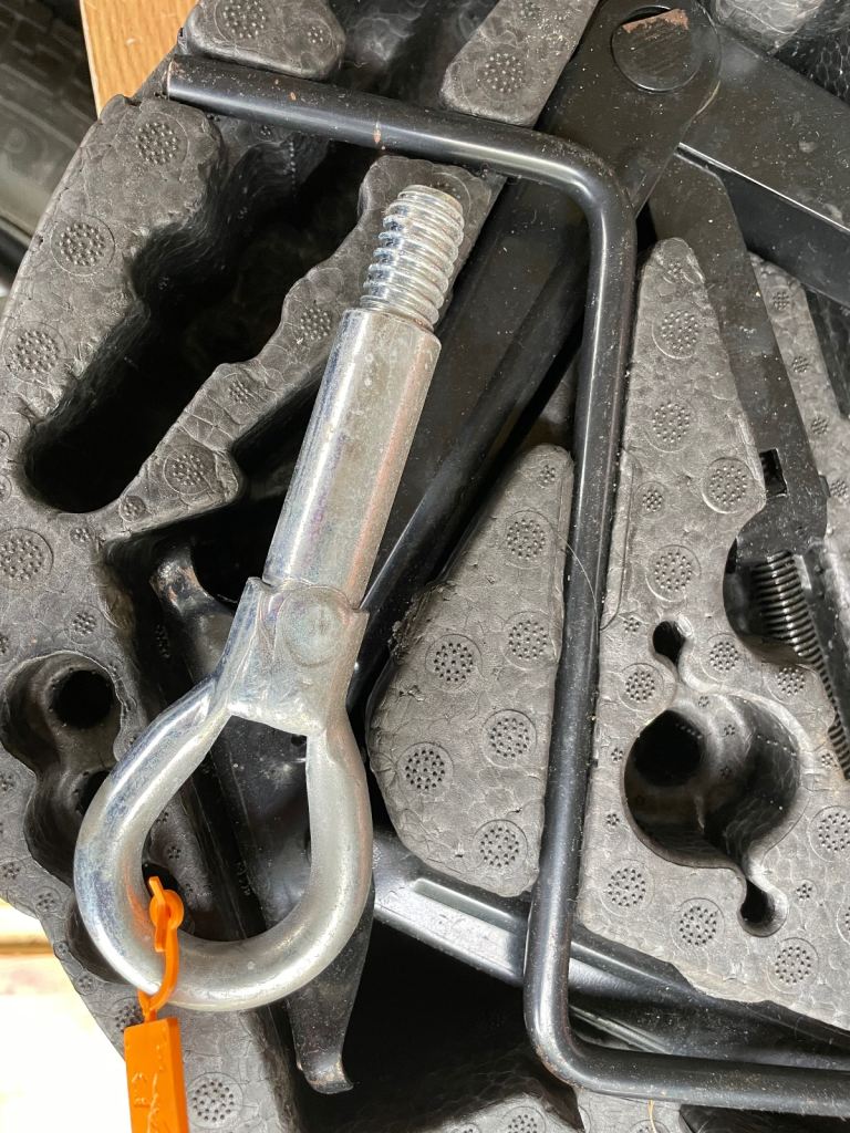 Spare tyre with toolkit