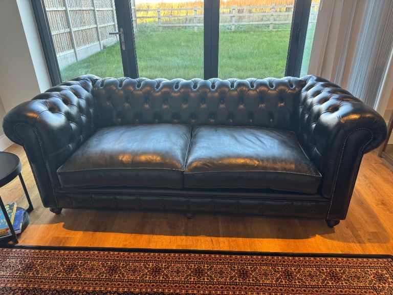 A set of leather chesterfield sofas