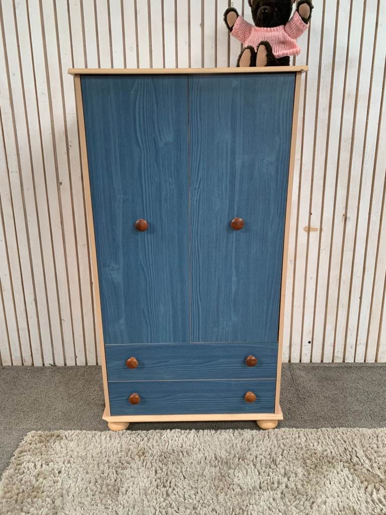 Children's Cupboard with Two Blue Drawers, Two Doors, and Interior Shelves.