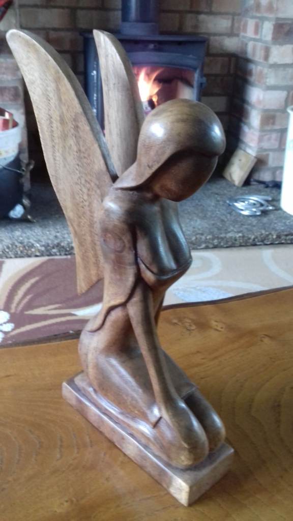 Wooden Seated angel and singing monk