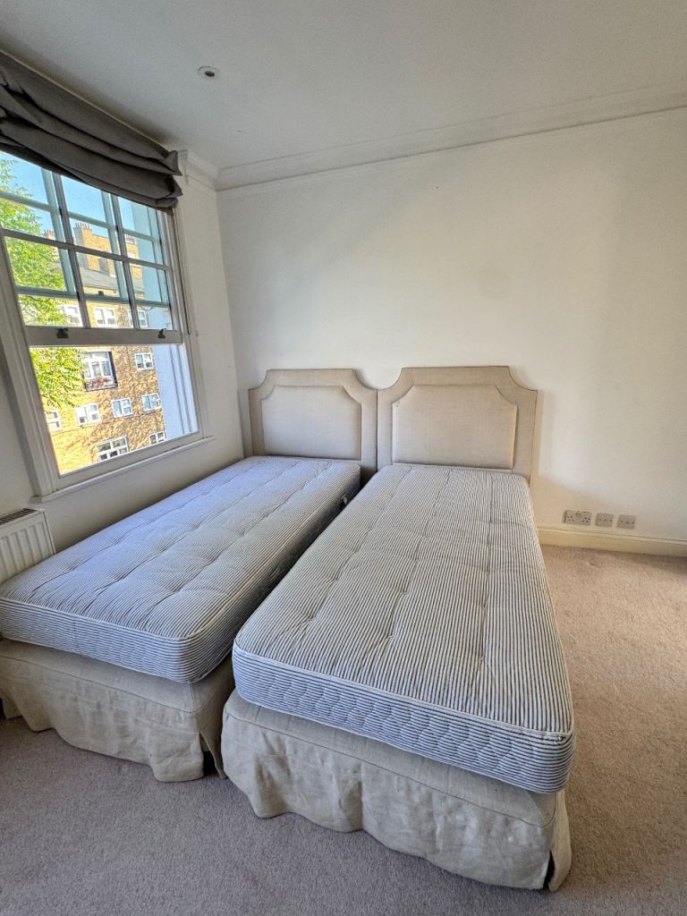 2 single beds w/ headboards and mattresses 