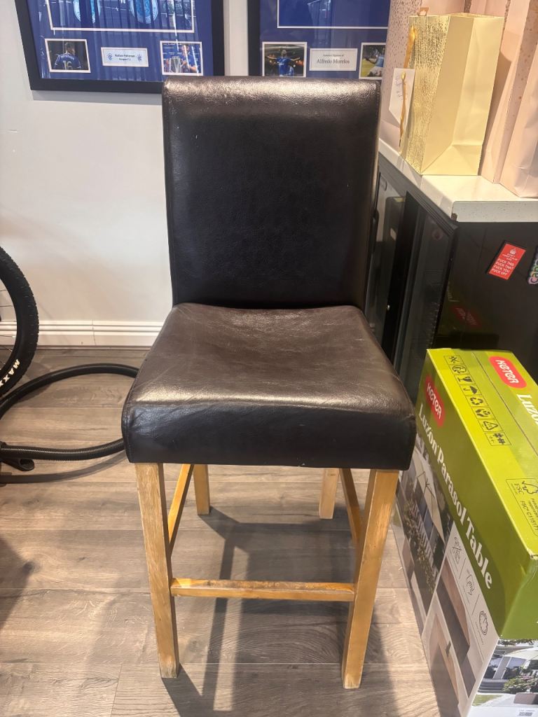 Good quality bar stool with a dark brown leather-look padded seat and back