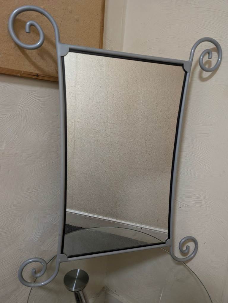 Metal framed wall mirror.