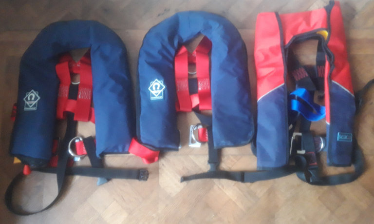 Three junior auto lifejackets