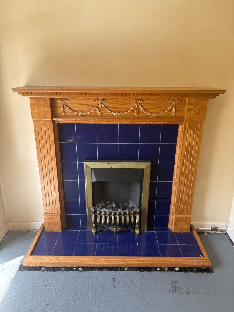Wooden Fireplace with Blue Tiles and Fire Basket