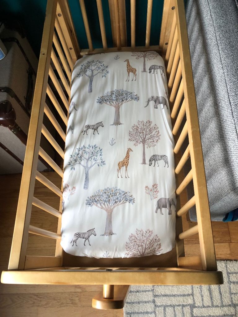 Wooden Rocking Cradle with mattress and sheet. 
