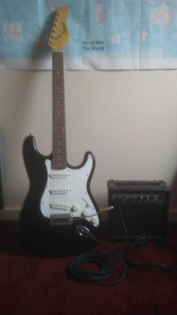 Encore guitar with tremelo arm, lead and practice amp