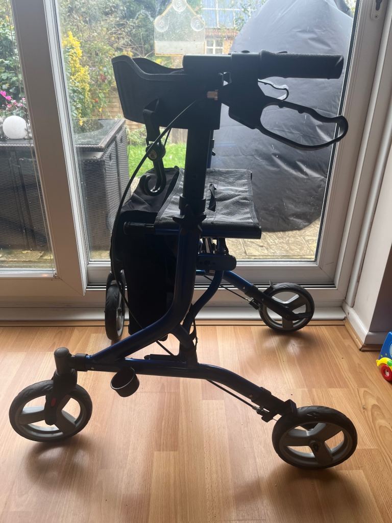 Wheeled Blue walker with knee rest, shopping bag, and brakes 