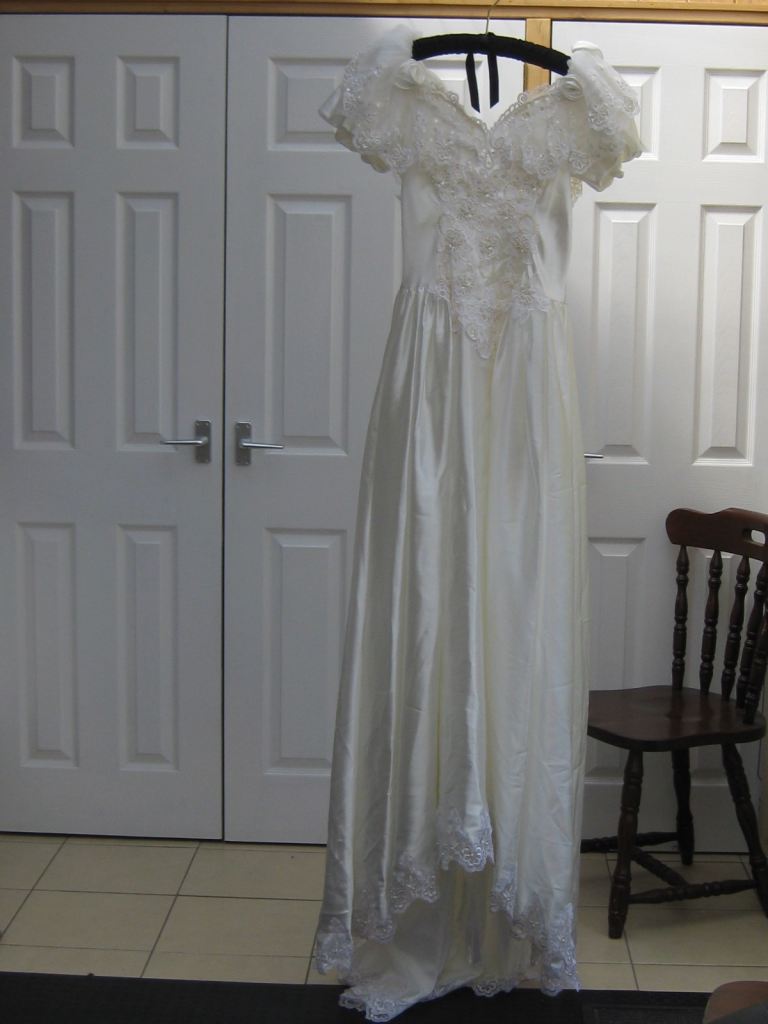 Wedding dress with beaded  top and short sleeves .