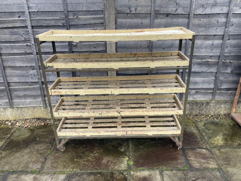vintage industrial shelving unit likely served as a bakery trolley or a factory shoe rack ?? 