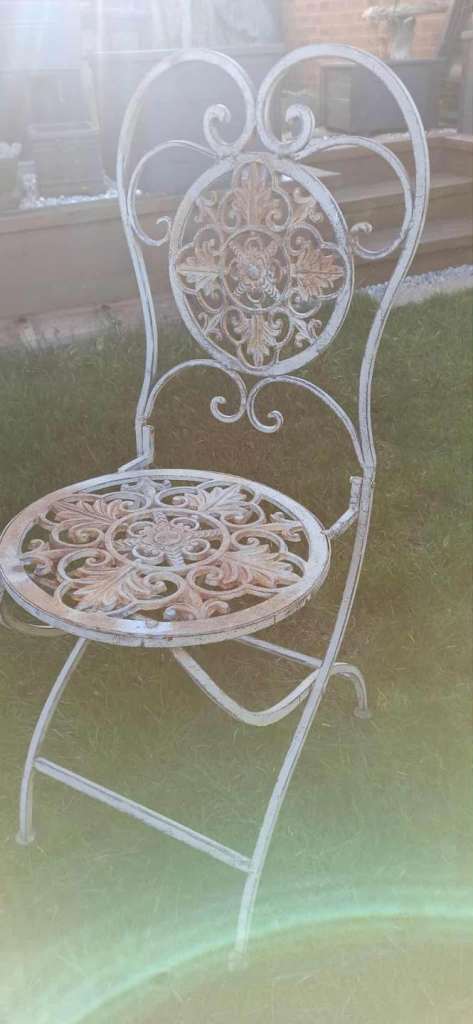 Wrought iron garden furniture set, vintage bistro set with a table and two chairs. 