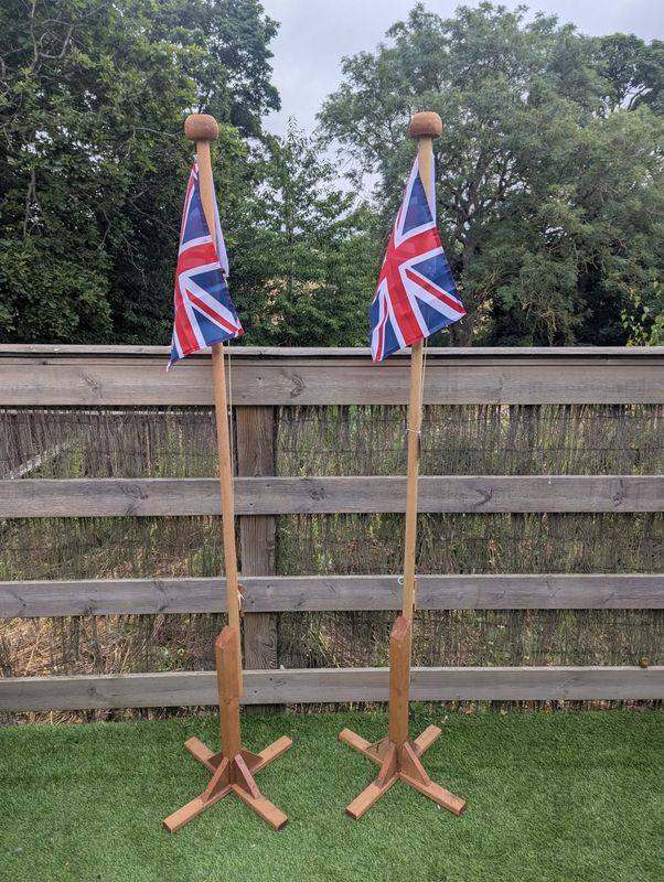 Pair of Union Jack flags with freestanding flag poles