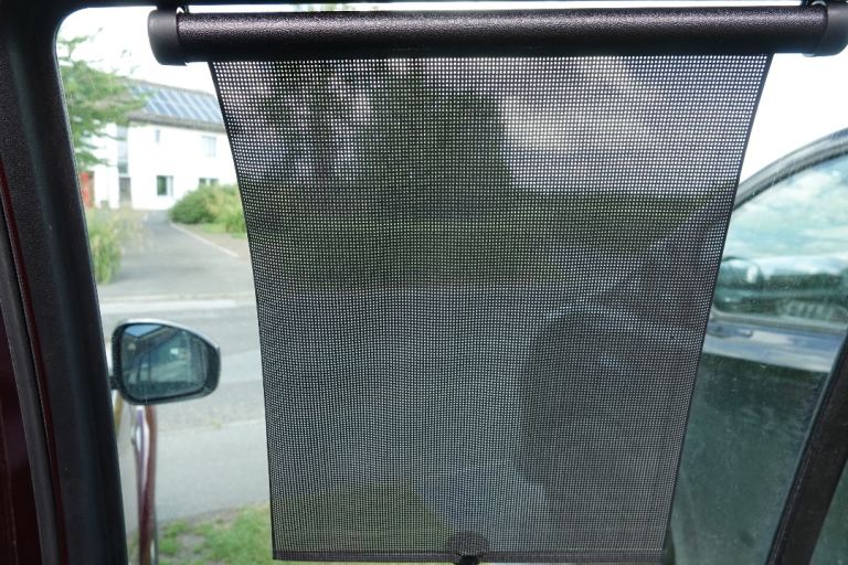 Car passenger window spring loaded retractable roller sun blind