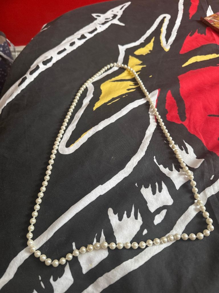 Woman’s white pearl necklace