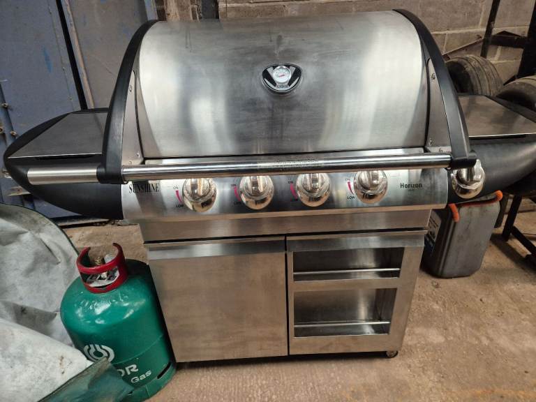 Gas Barbeque with bottle and cover.