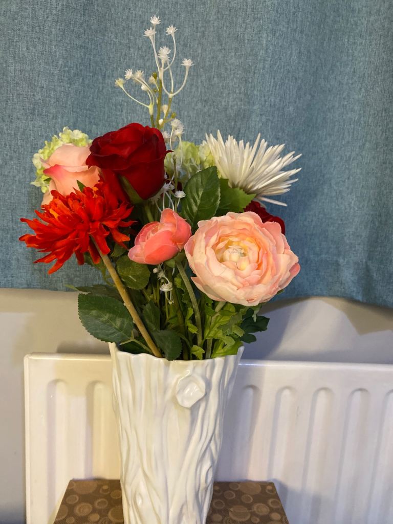 Vase with artificial flowers