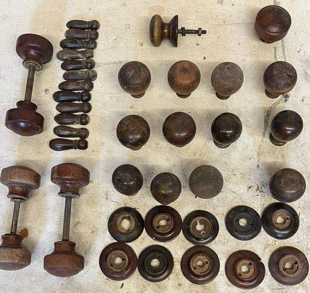 Antique hardwood door knobs and accessories, circa 1920.