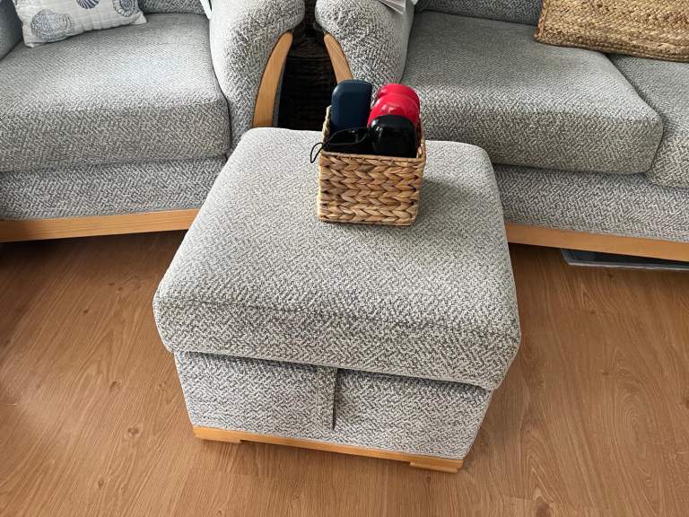 A two seater sofa, 2 x arm chairs and foot stall