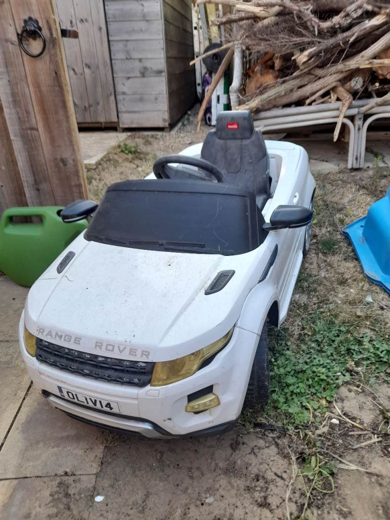 Kids sit in play car