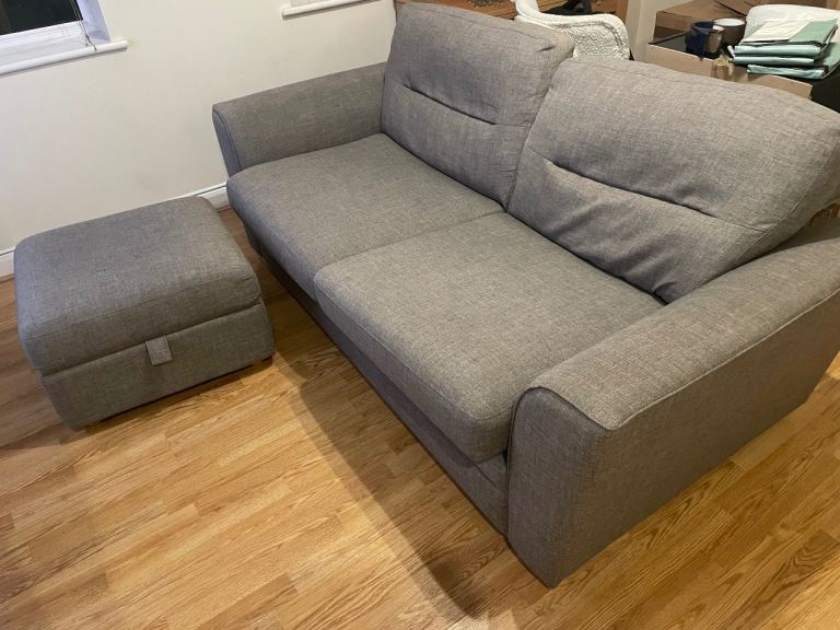 Grey two seater sofa and footrest 