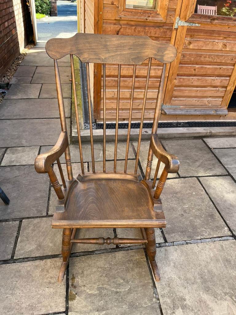 An attractive wooden rocking chair with spindle back.