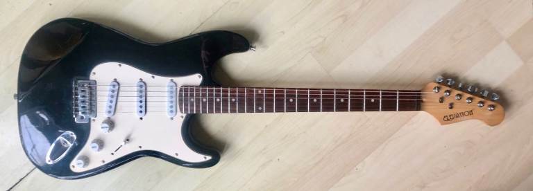 ELEVATION STRAT TYPE ELECTRIC GUITAR AND STAND. PLAYS AND SOUNDS GREAT.