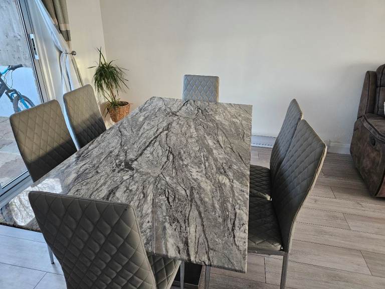 Grey marble dinning table and six chairs 