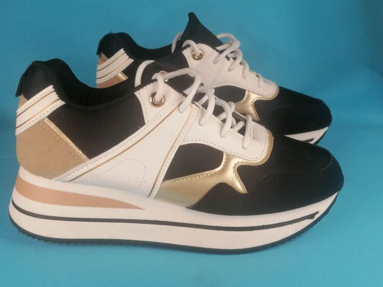 Very good condition Woman's Trendi  Fashionable Black and Gold  sneakers High top..