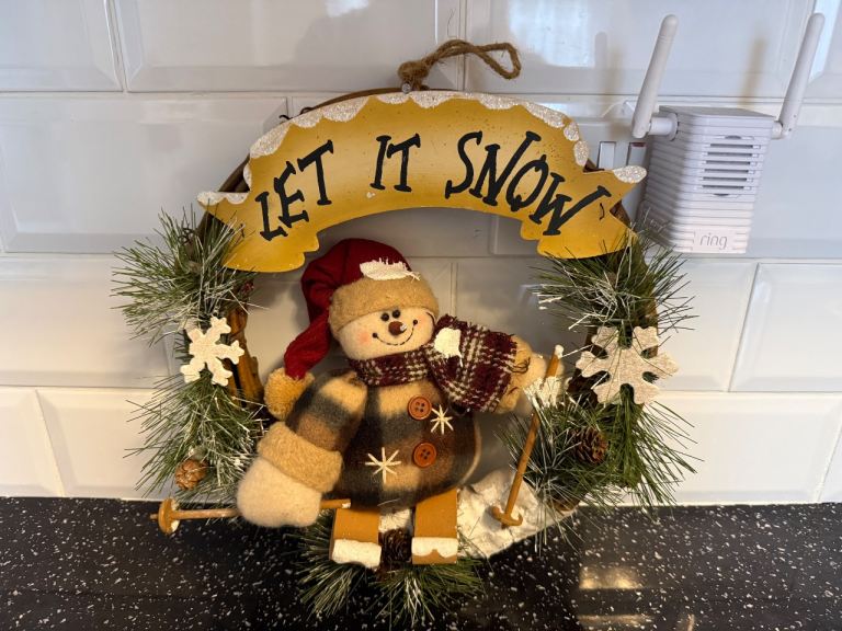 Snowman on Skis Christmas wreath featuring a plush Snowman figure and a "Let It Snow" sign 14" 