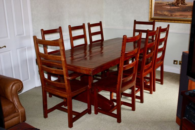 Solid African teak dining table and 8 chairs