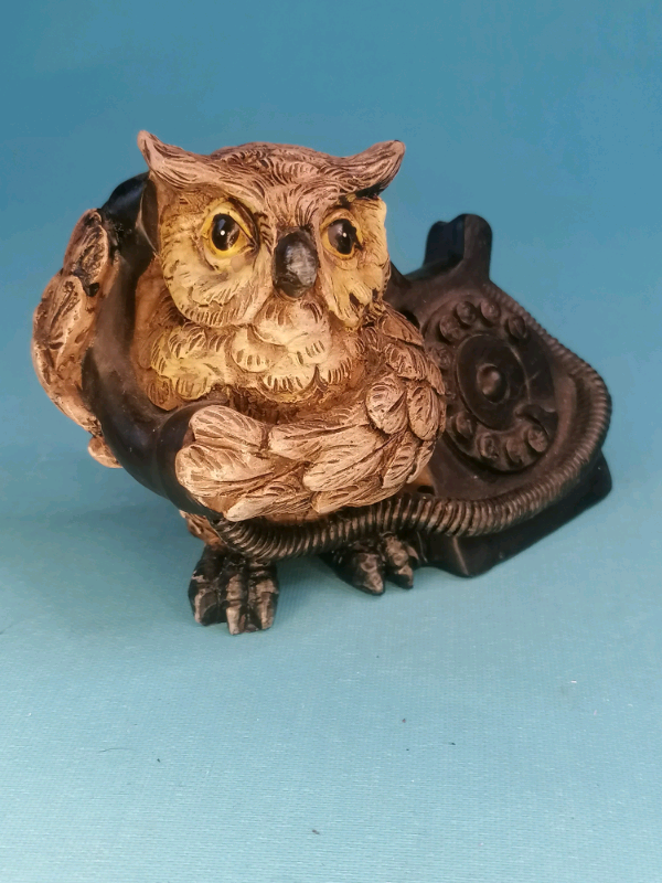 4-inch forest owl small sculpture speaking with phone. 